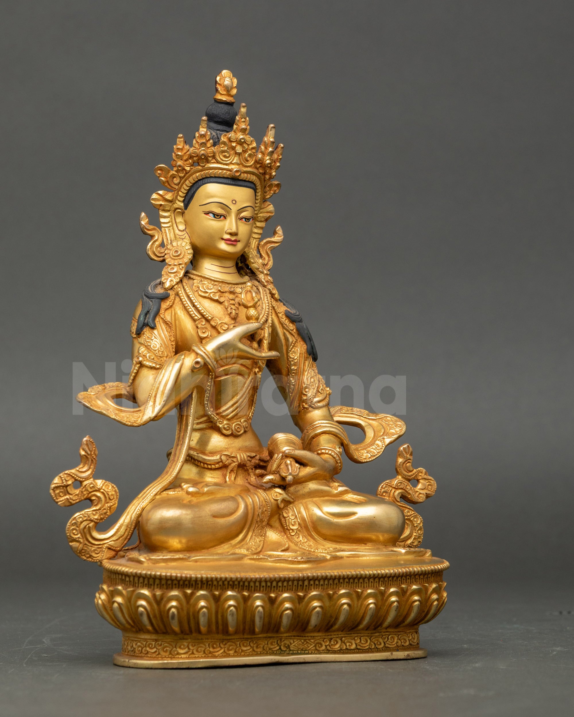 Side view of Vajrasattva holding vajra and bell, seated on serene lotus throne