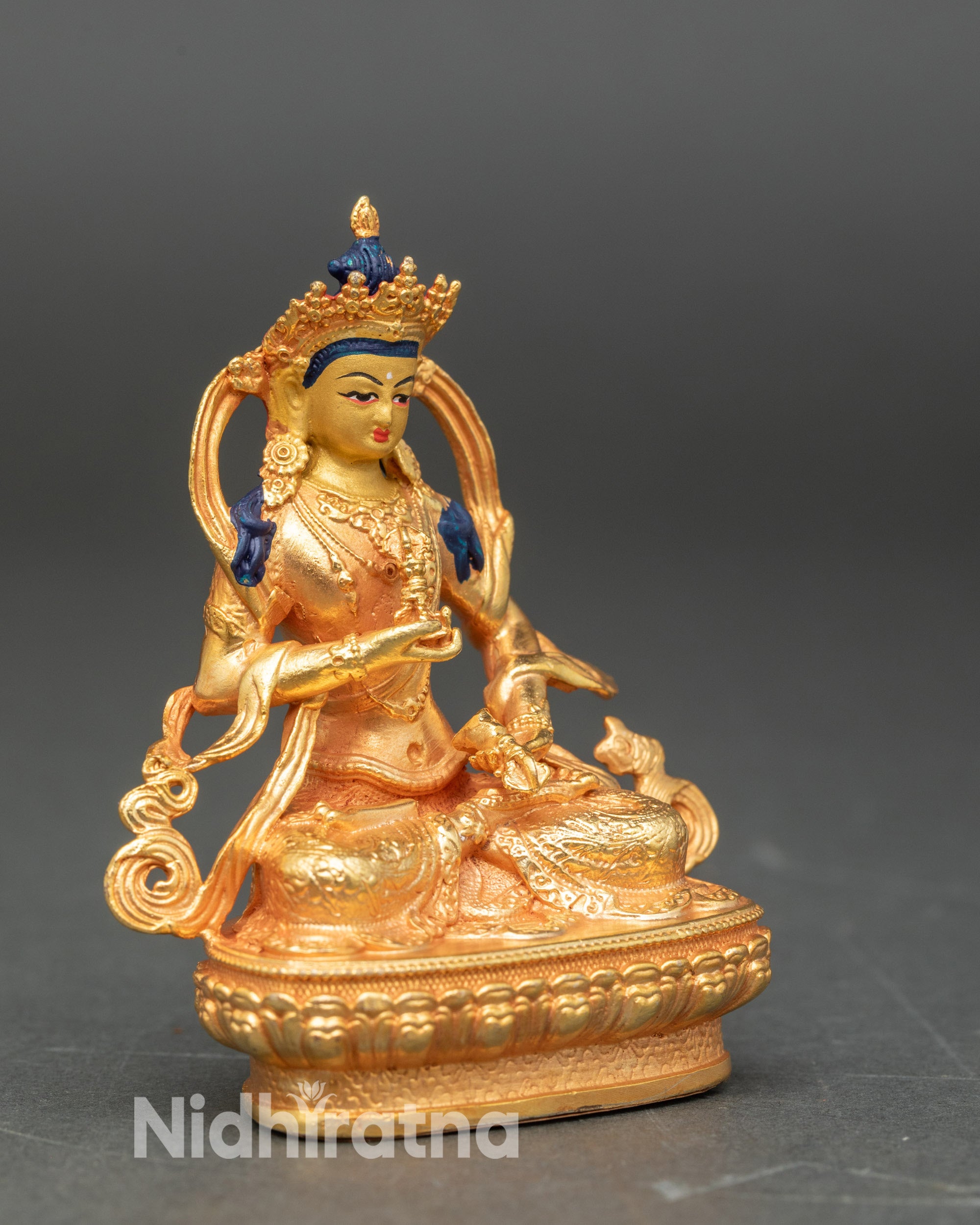 Side view of Vajrasattva seated on lotus pedestal, gold-finished Himalayan sculpture
