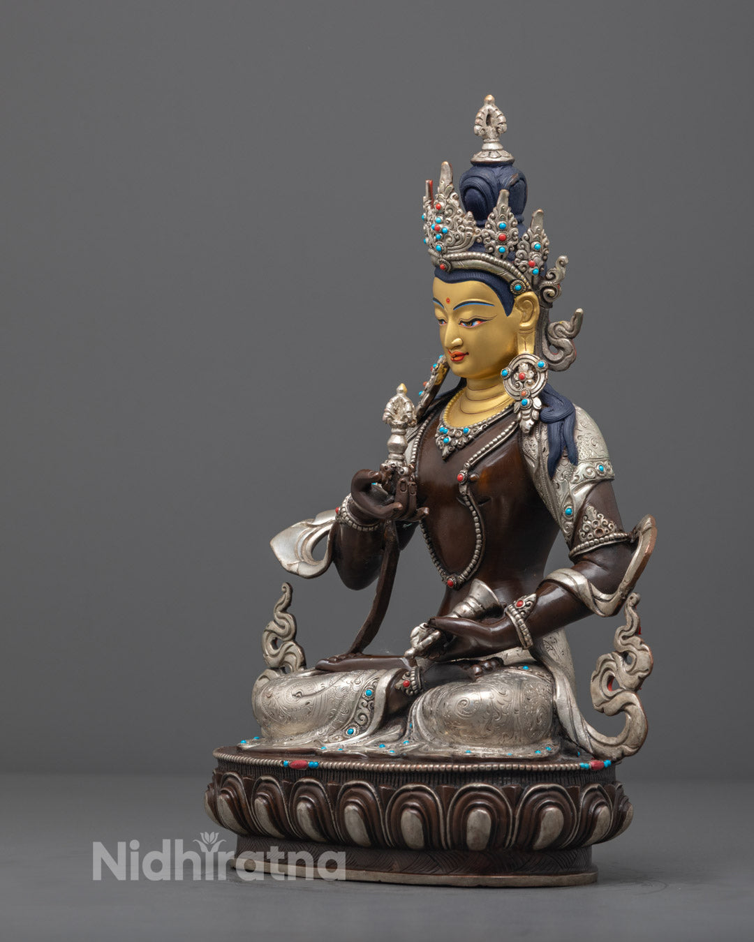 Vajrasattva statue showing the vajra in the right hand and bell in the left, symbolizing the union of wisdom and compassion.

