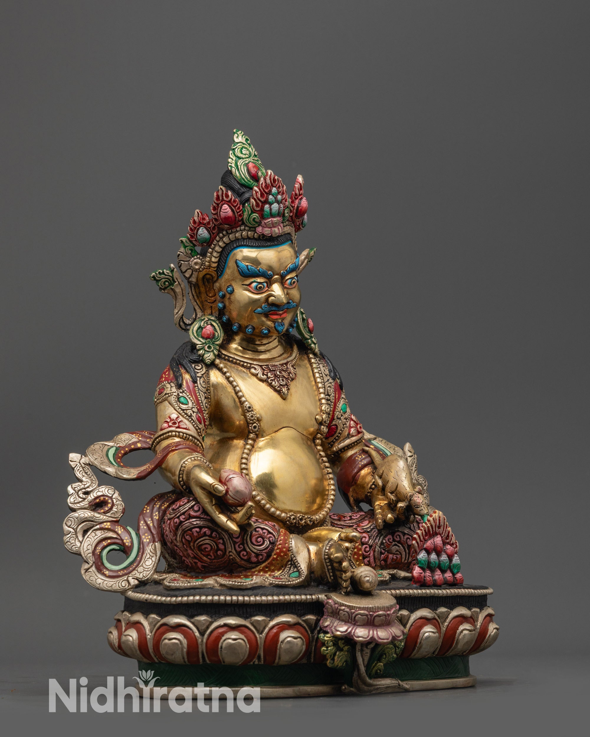 Side view of Vajrayana Dzambhala statue seated on lotus with flowing silver-plated robe
