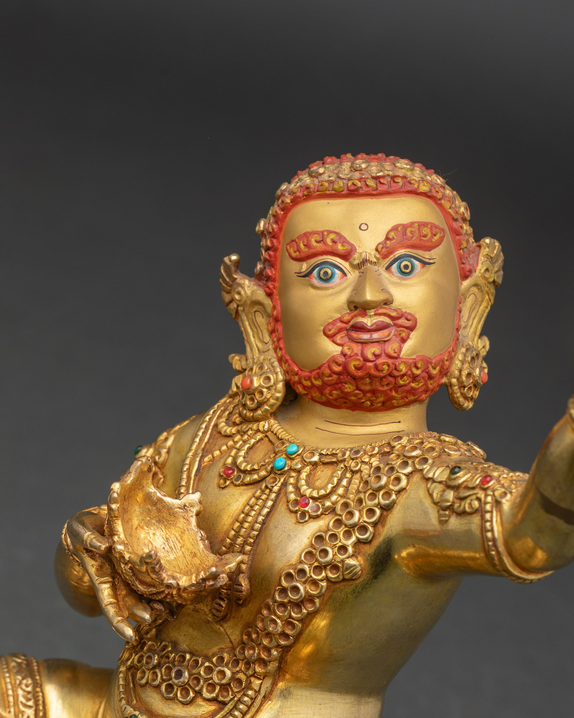 Side view of Virupa statue highlighting raised hand and ornate jewelry