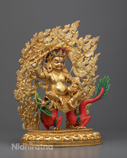 Side view of White Dzambhala statue seated on lotus base with fire halo