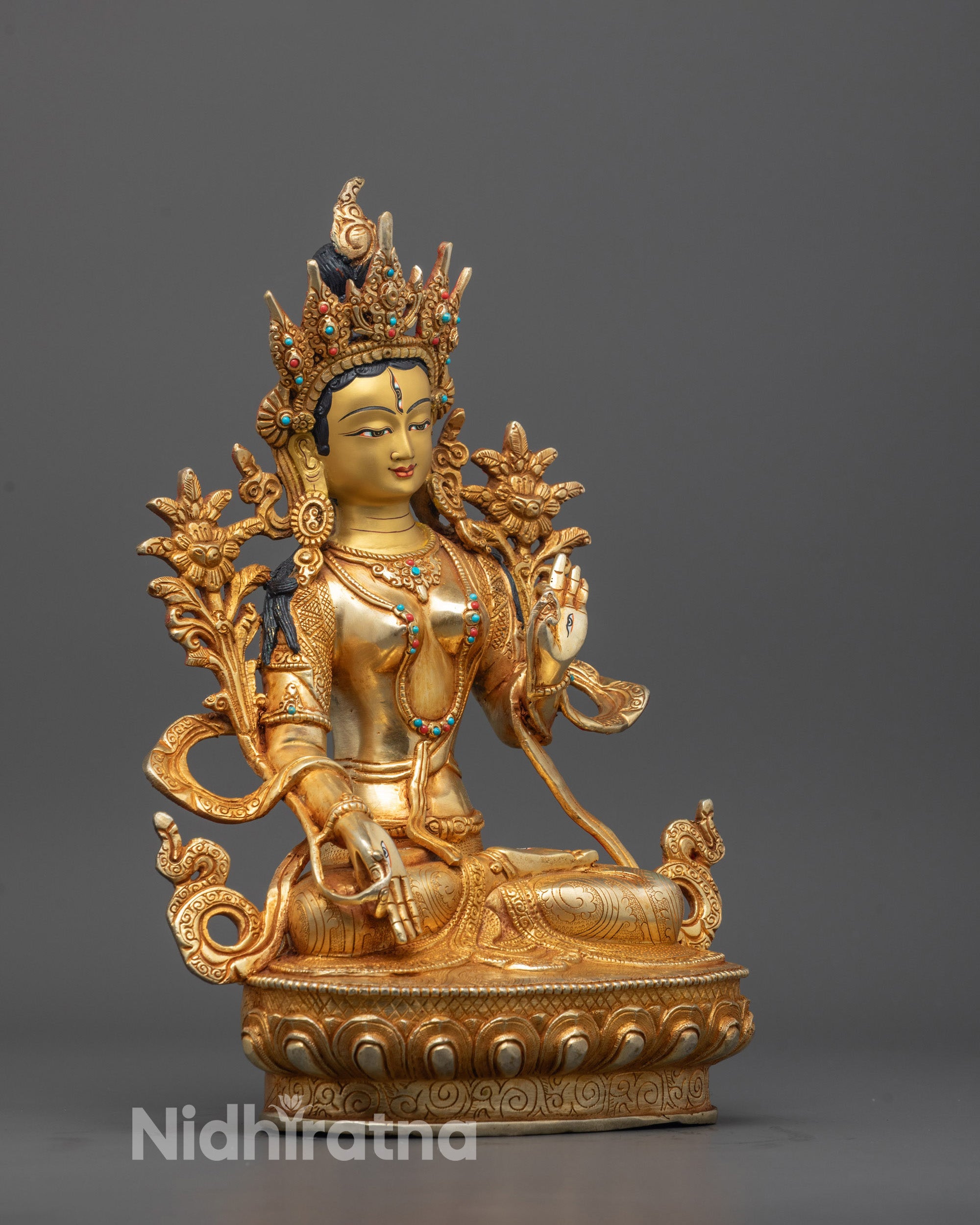 Side view of White Tara Buddha statue showing detailed facial features