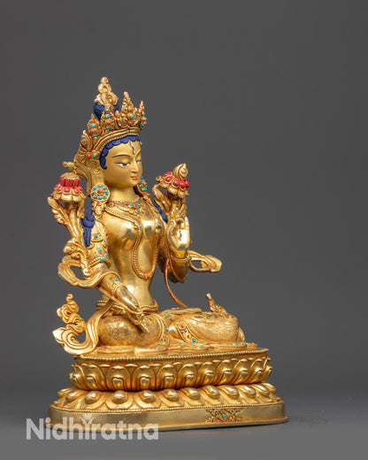 Side view of White Tara Statue holding utpala stem with flowers and flowing robe
