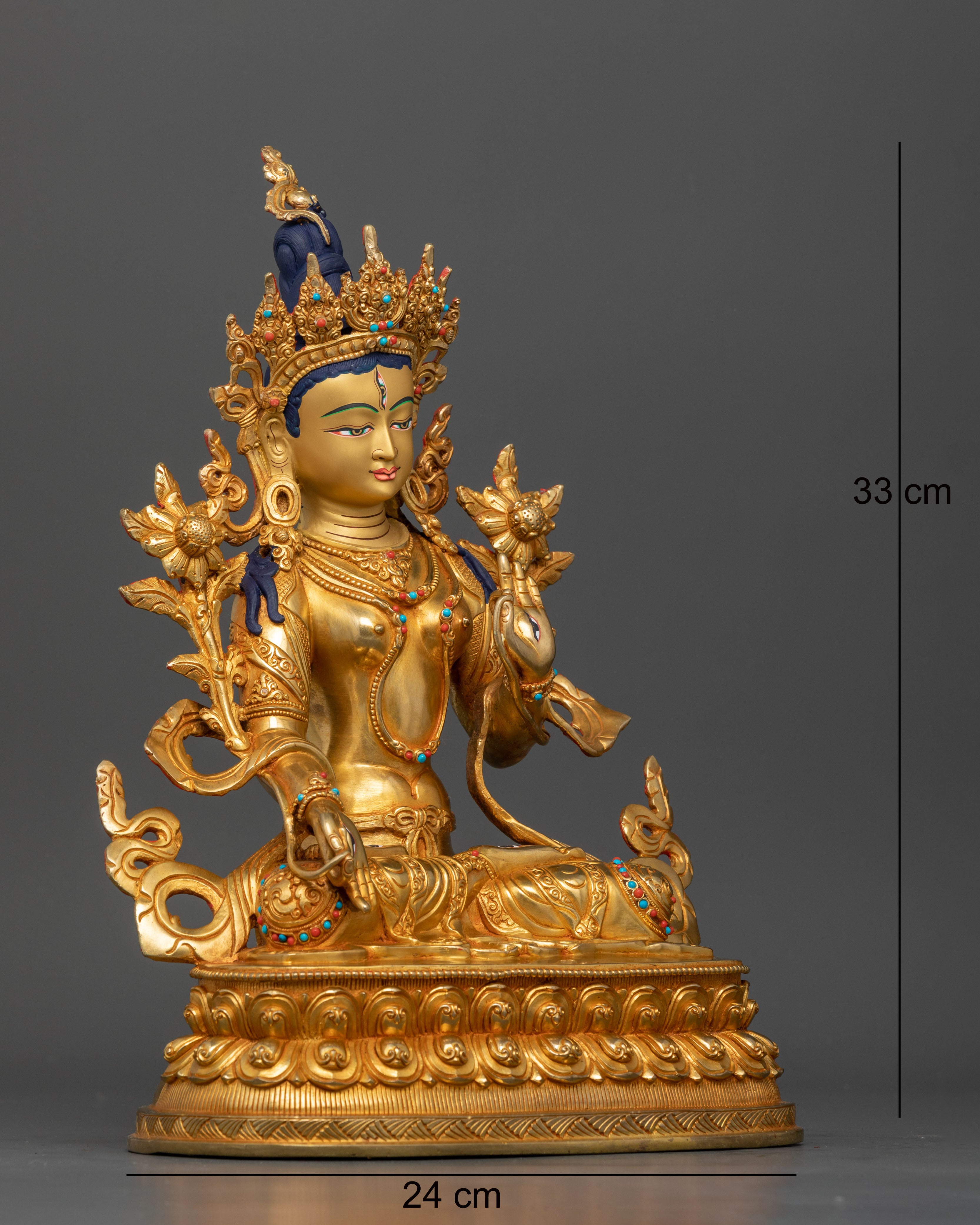 Side view of White Tara deity statue showing flowing robes and intricate lotus pedestal