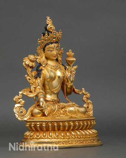 Side view of White Tara holding utpala flower, handcrafted Nepalese copper statue