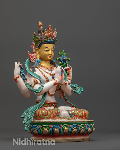 Side view of colored Avalokiteshvara statue highlighting flowing robe and detailed lotus seat

