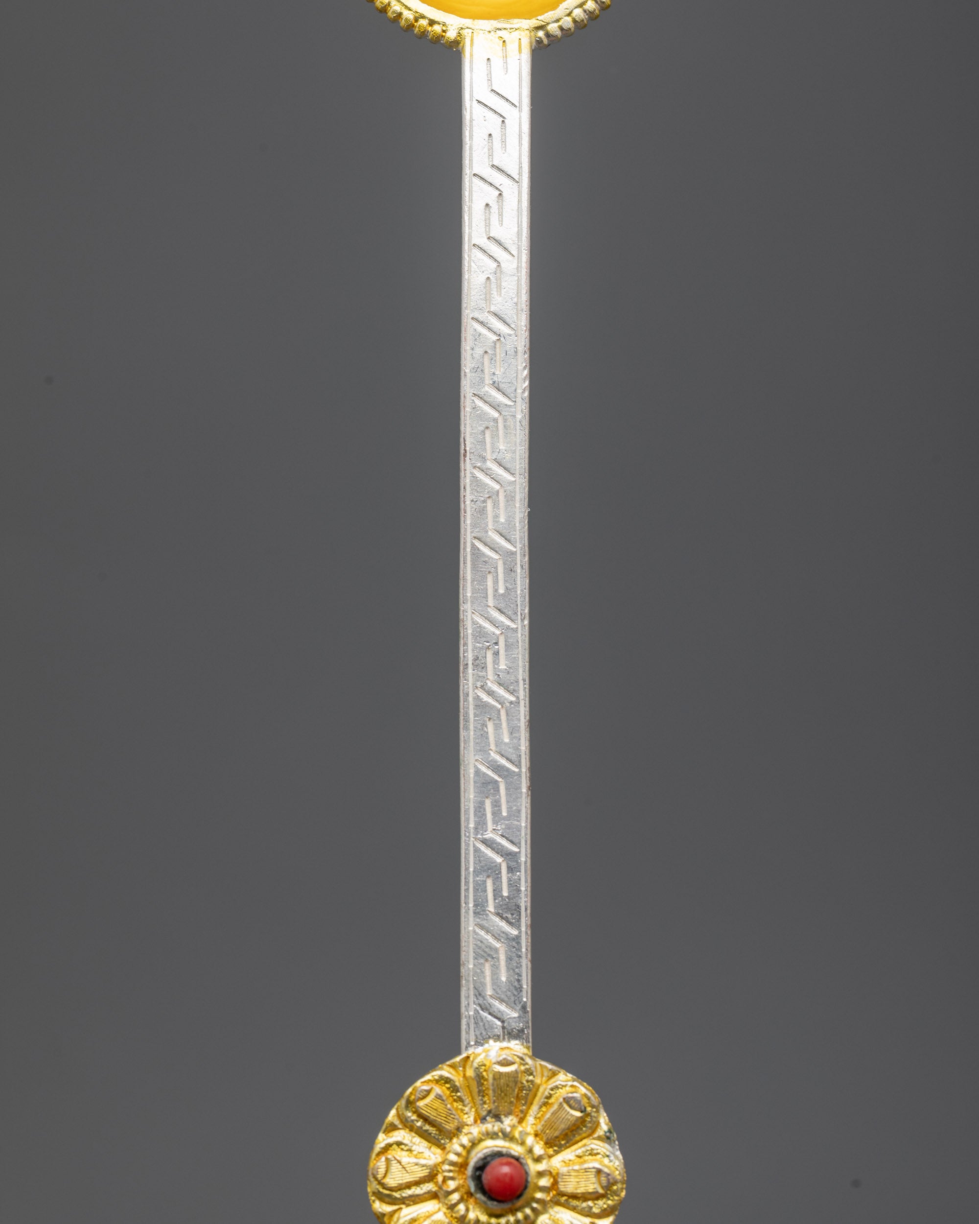 Side view of copper Tibetan Spoon with gold and silver-plated finish