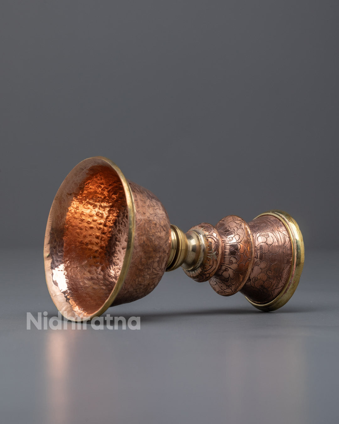 Side view of copper butter lamp designed for yak butter or oil offerings