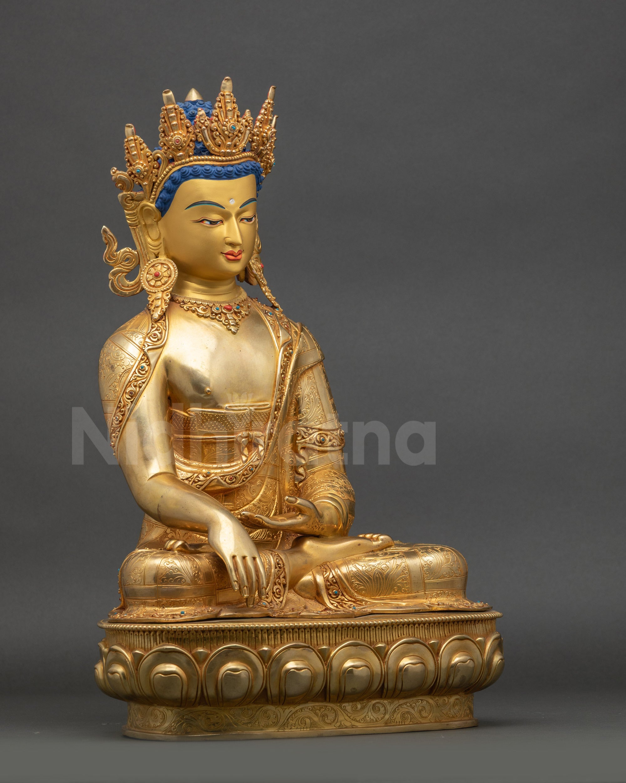 Side view of crowned Shakyamuni Buddha statue highlighting crown and seated posture