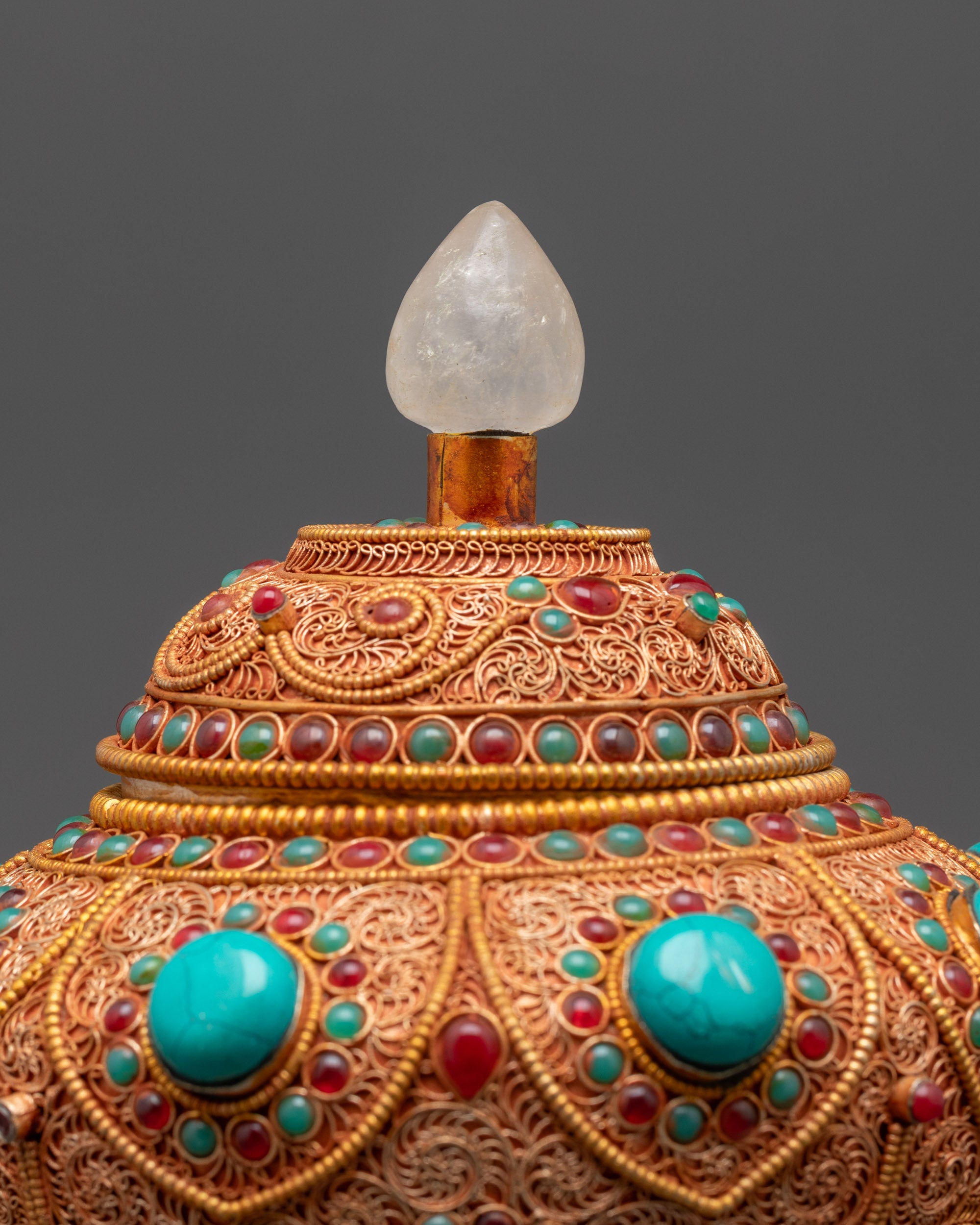 Side view of crystal-topped copper Neshi Rice Pot with intricate filigree work