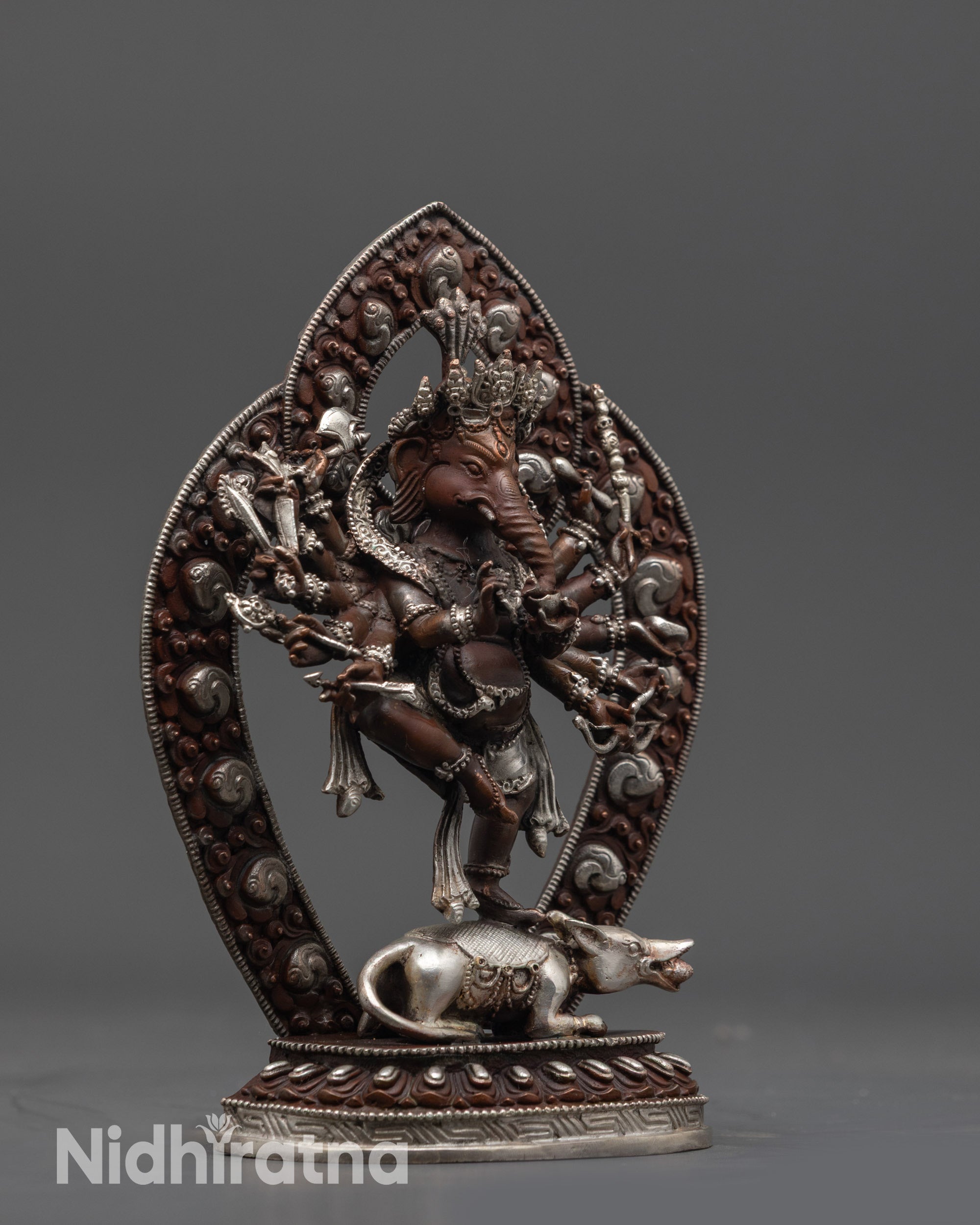 Side view of dancing Ganesh Murti atop Silver Mushika with oxidized halo and carvings