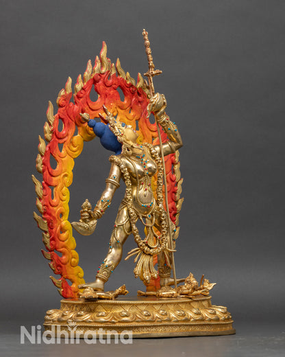 Side view of dancing Vajrayogini on lotus pedestal with blazing halo and skull crown