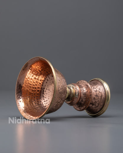 Side view of detailed Himalayan copper butter lamp for puja and meditation