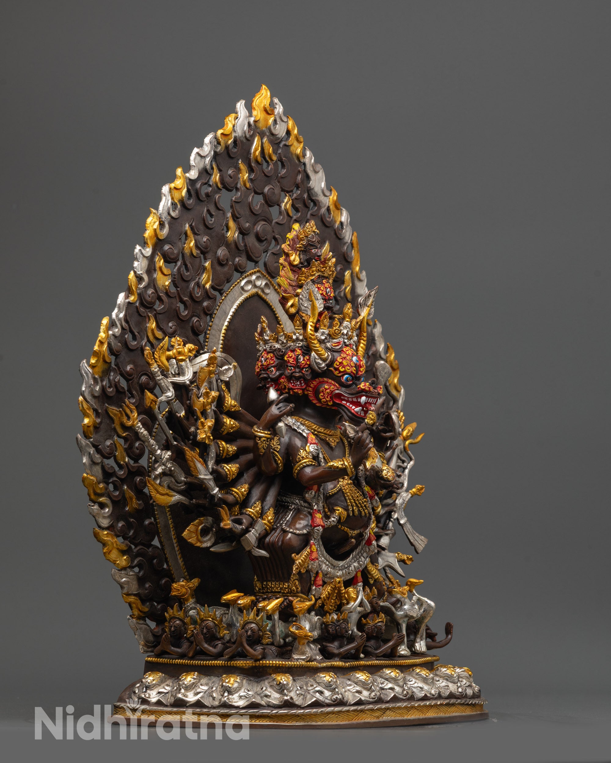 Side view of fierce Yamantaka Statue holding kartika knife and kapala on oxidized copper body