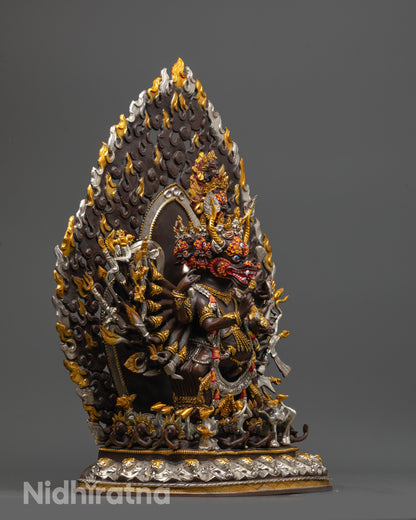 Side view of fierce Yamantaka Statue holding kartika knife and kapala on oxidized copper body