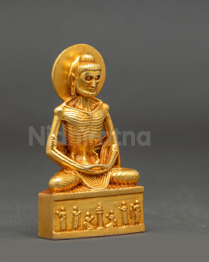 Side view of gold fire-gilded Fasting Buddha statue highlighting ascetic emaciated form