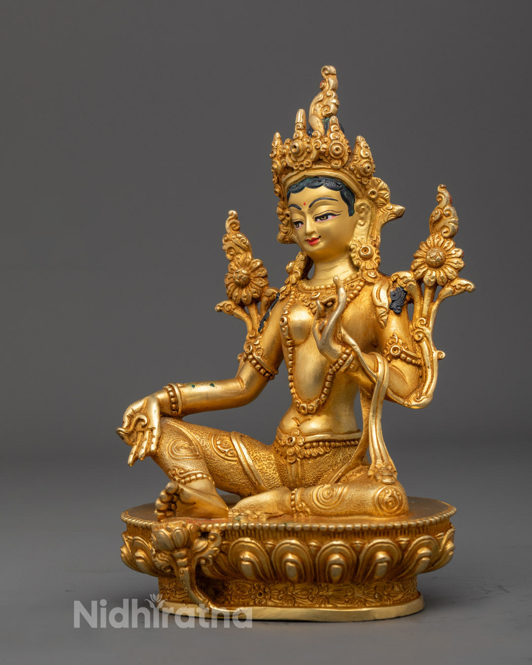 hand-painted Green Tara sculpture showcasing traditional Tibetan Buddhist ornamentation and vibrant colors.