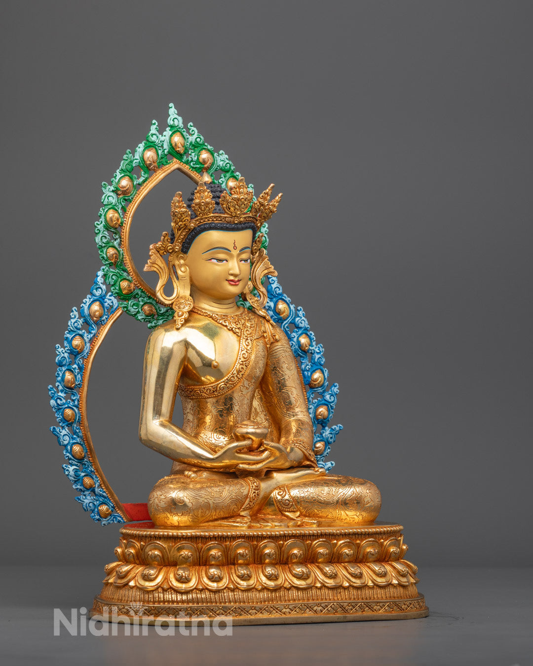 Side view of handcrafted Amida Buddha showing detailed crown and painted halo
