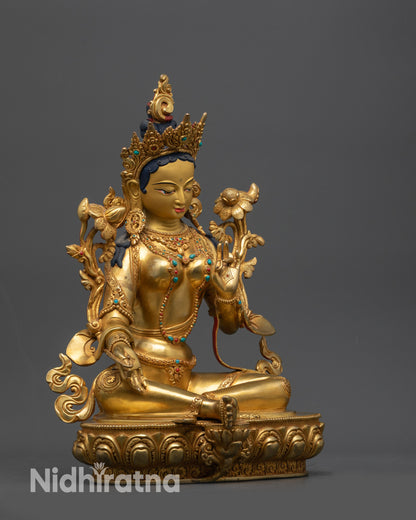Side view of handcrafted Green Tara Sculpture highlighting carved robe and semi-precious stones
