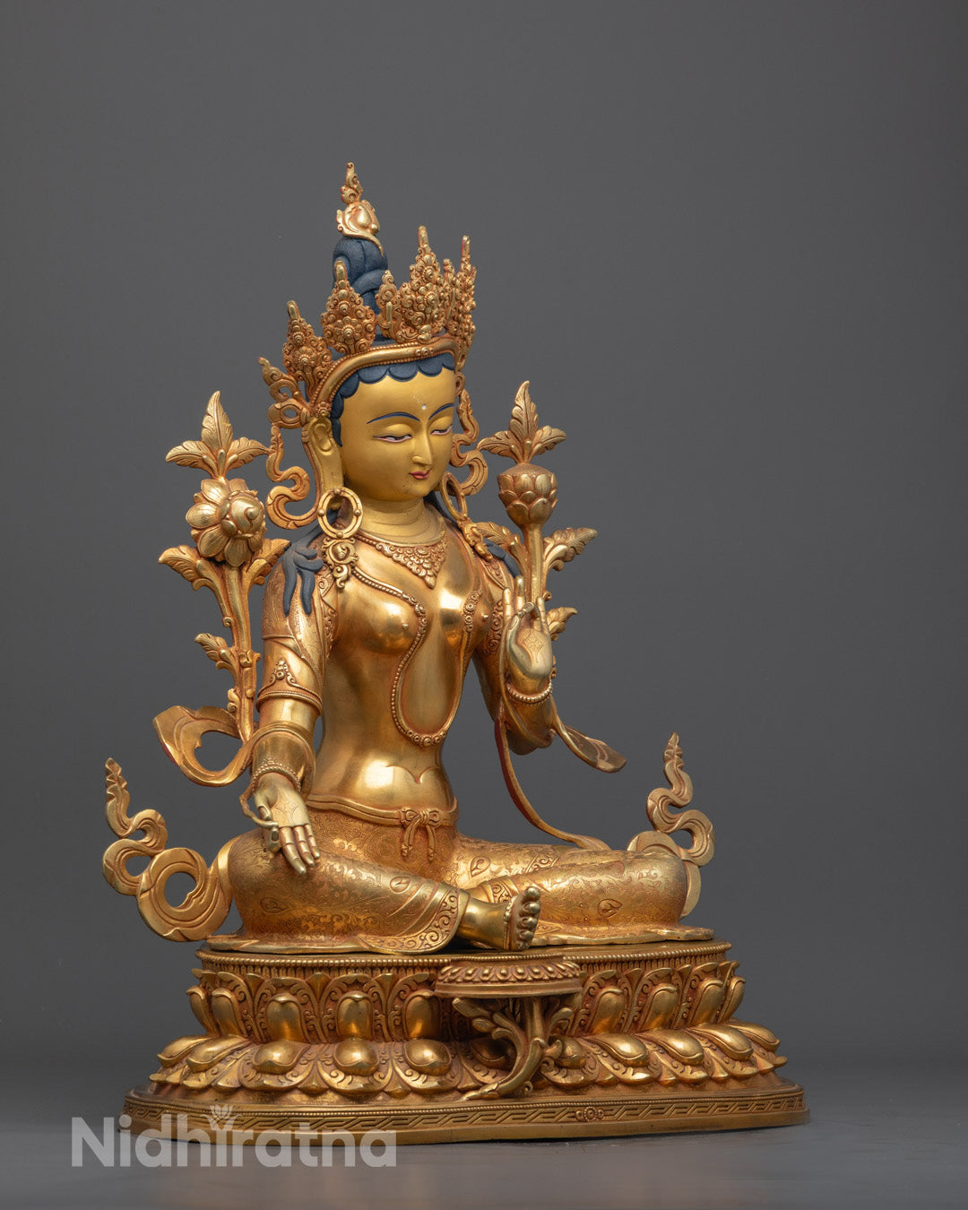 Side view of handcrafted Green Tara Sculpture highlighting intricate copper carvings