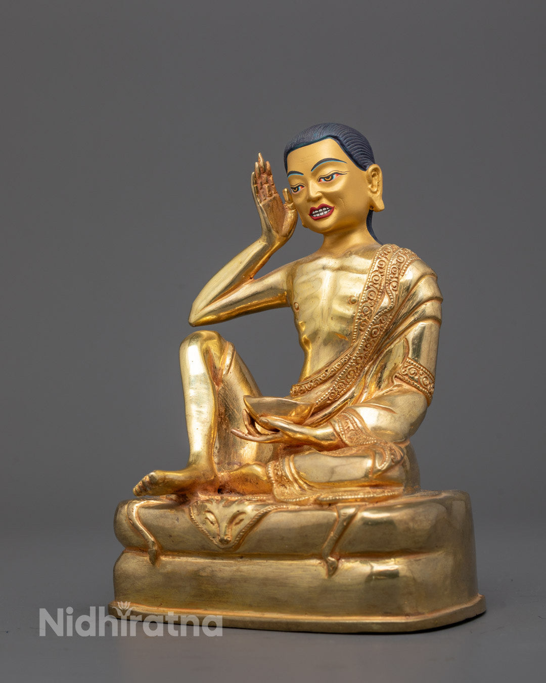 Side view of handcrafted Milarepa Statue seated on intricately carved throne
