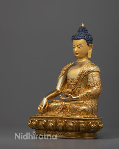 Side view of handcrafted Shakyamuni Buddha showing robe patterns and lotus seat