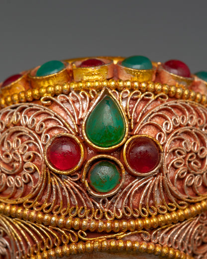 Side view of intricate filigree work on handcrafted Tibetan offering bowl