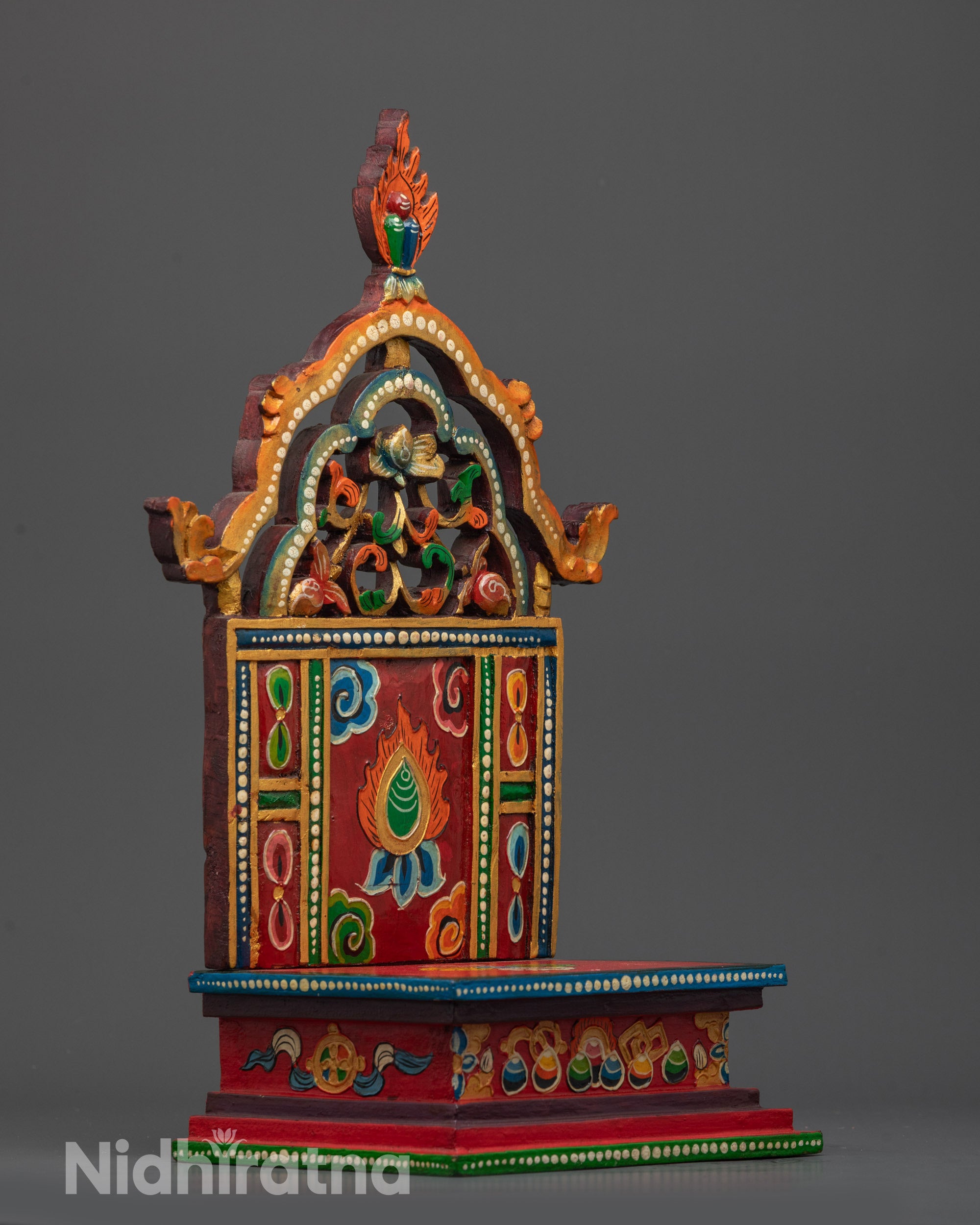 Side view of intricately painted shell on Nepalese handcrafted Buddhist Throne