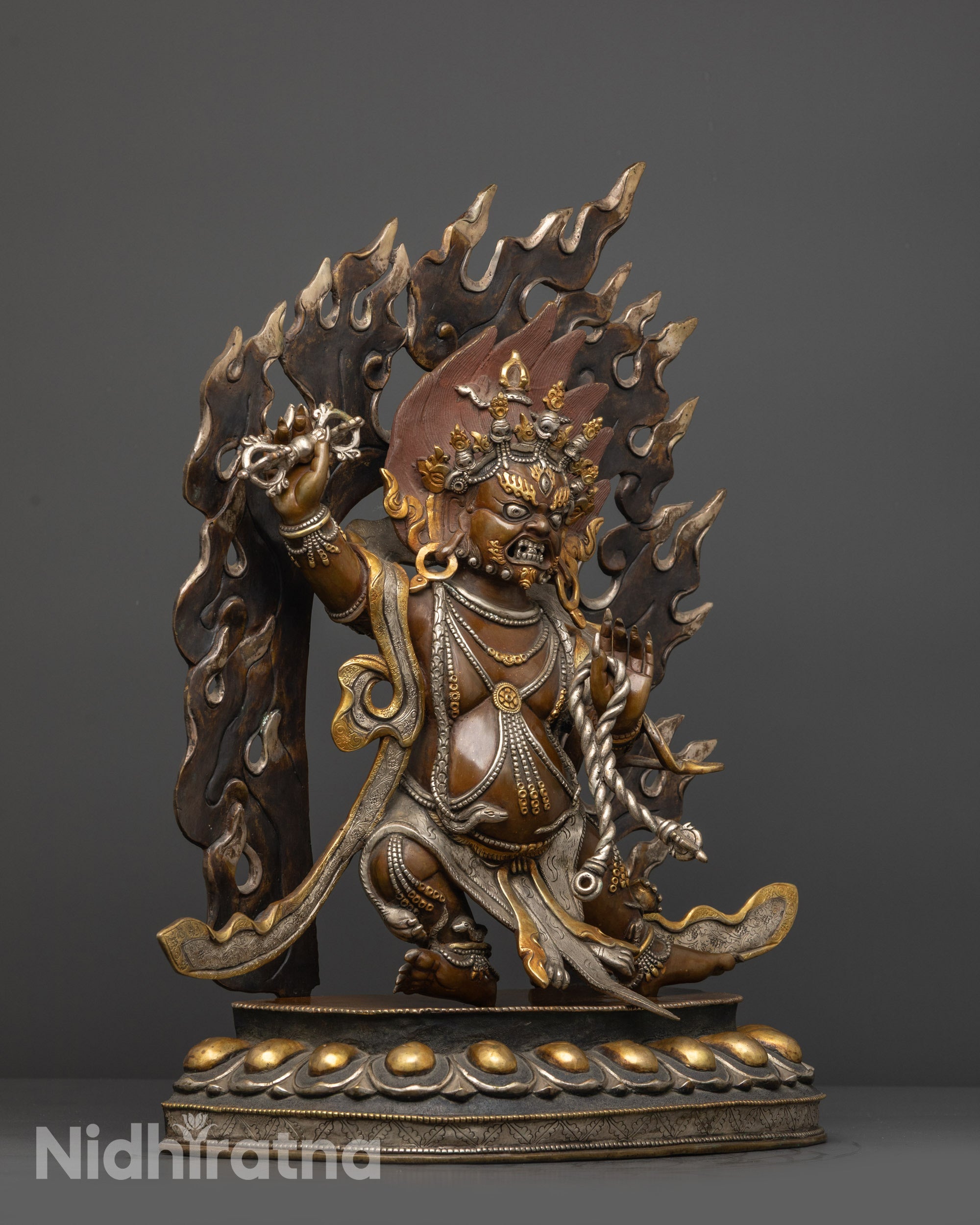 Side view of oxidized copper Vajrapani with tiger skin and patterned garments