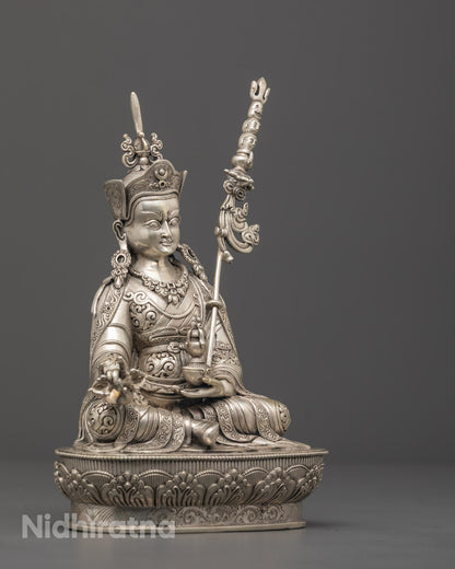 silver-plated Guru Rinpoche statue seated on a lotus base, symbolizing tantric wisdom and enlightenment