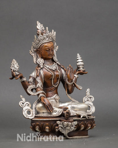 Side view of silver-plated Laxmi Statue, symbolizing Dharma, Artha, Kama, and Moksha