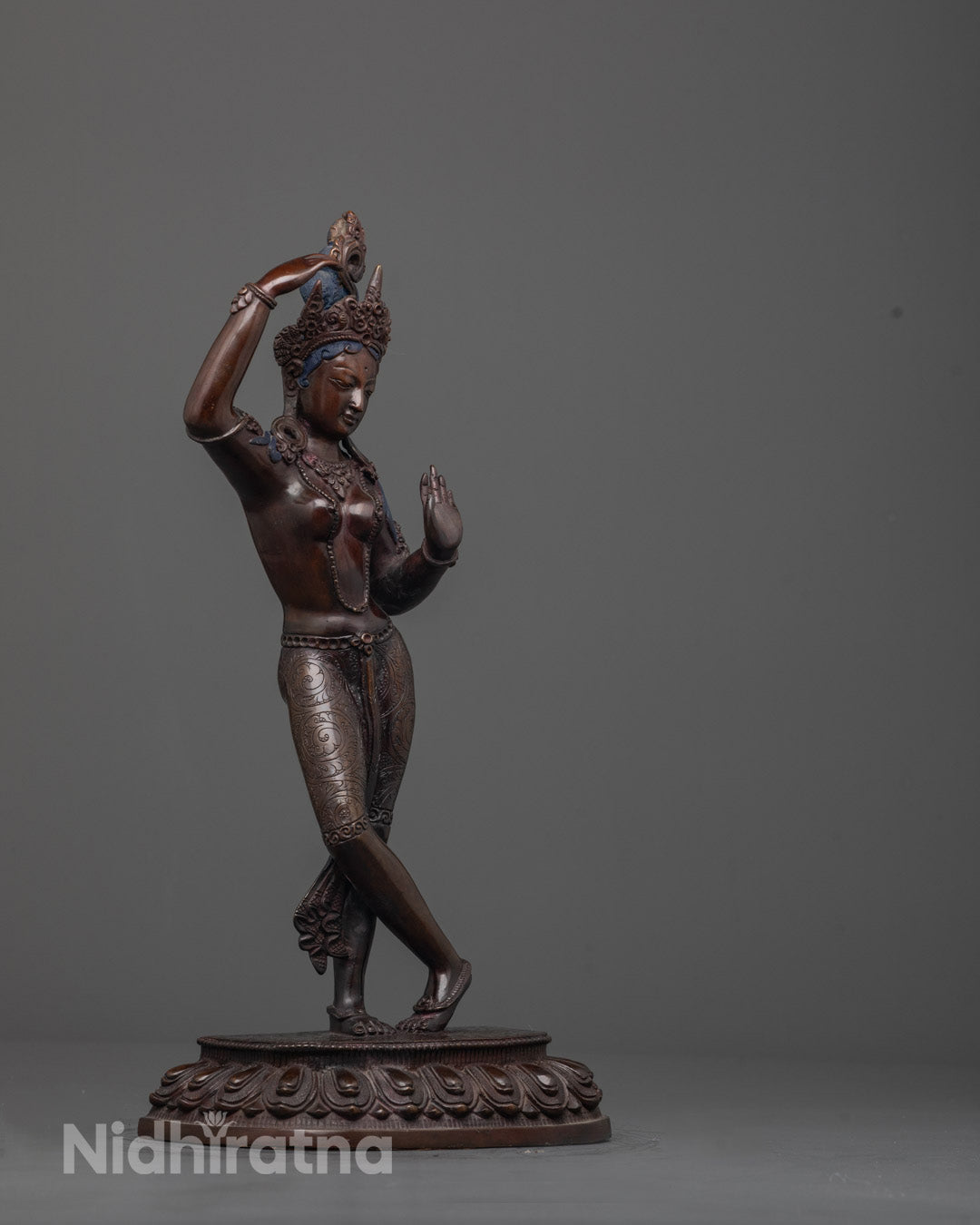 Side view of the Mayadevi Statue seated gracefully, featuring a hollow chamber