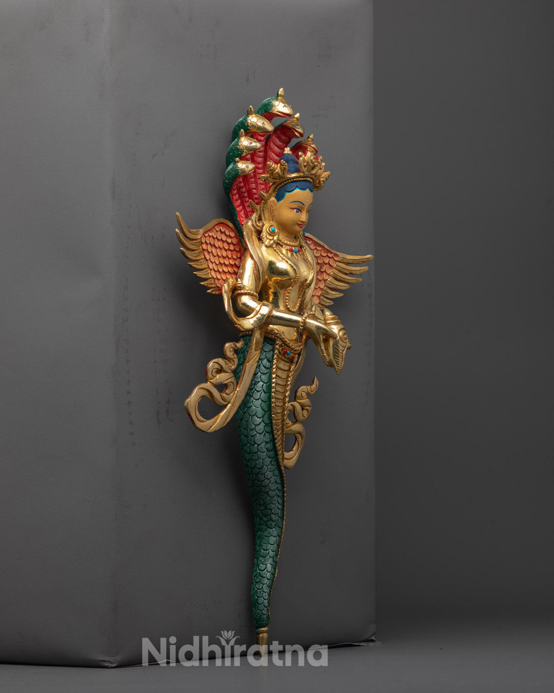 Side view of the Naga Kanya Statue highlighting the intricately carved wings