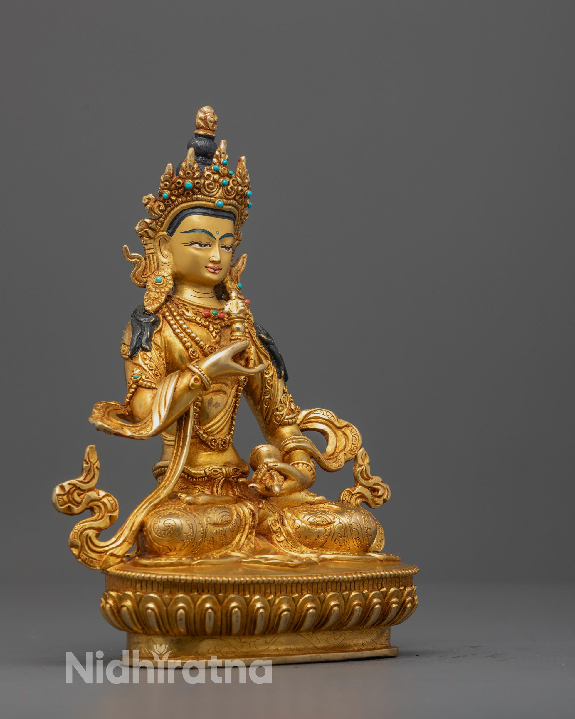 Side view of the copper Vajrasattva Statue highlighting the symbolic vajra and bell
