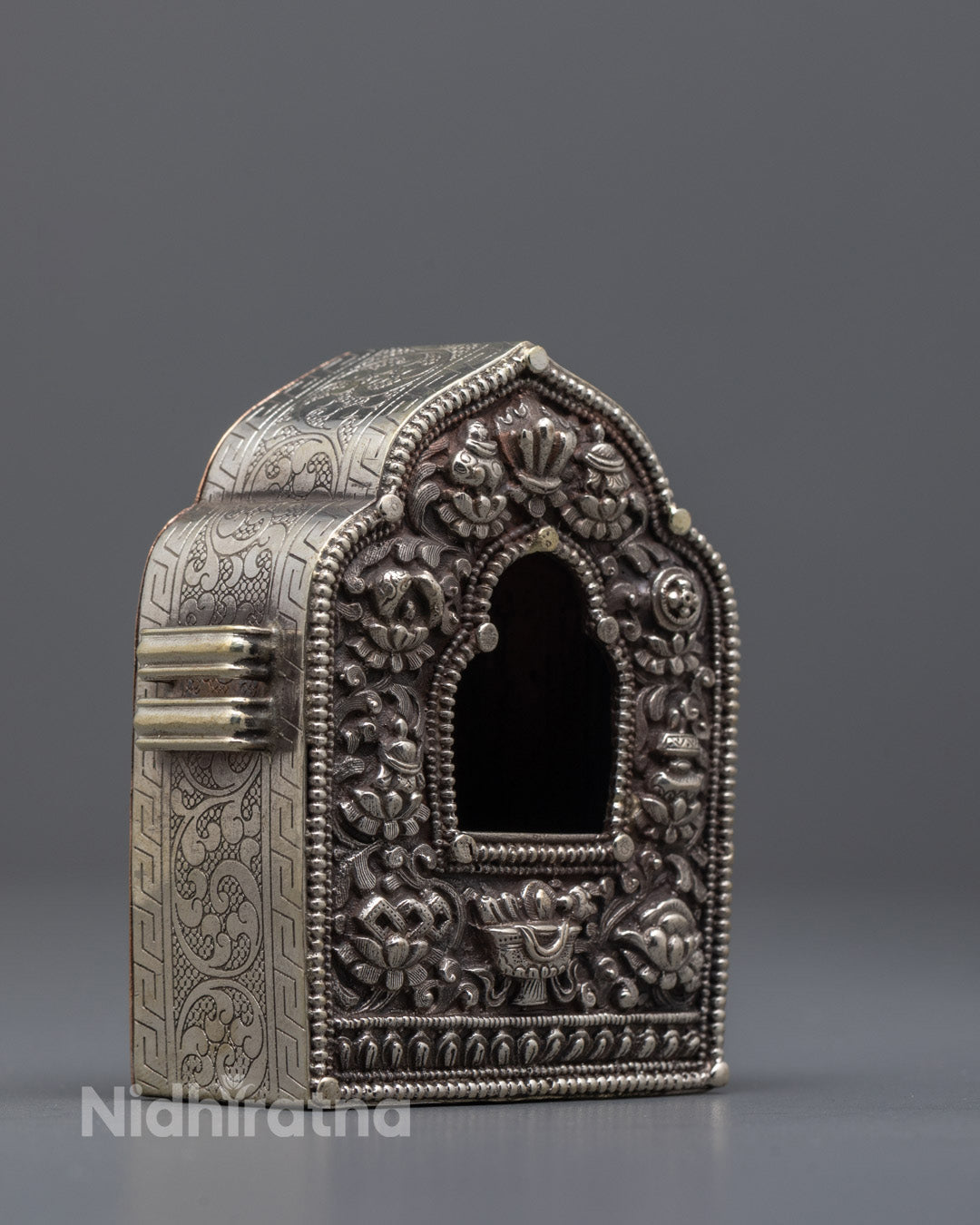 Side view of the traditional Nepali Ghau Box showing silver detailing 