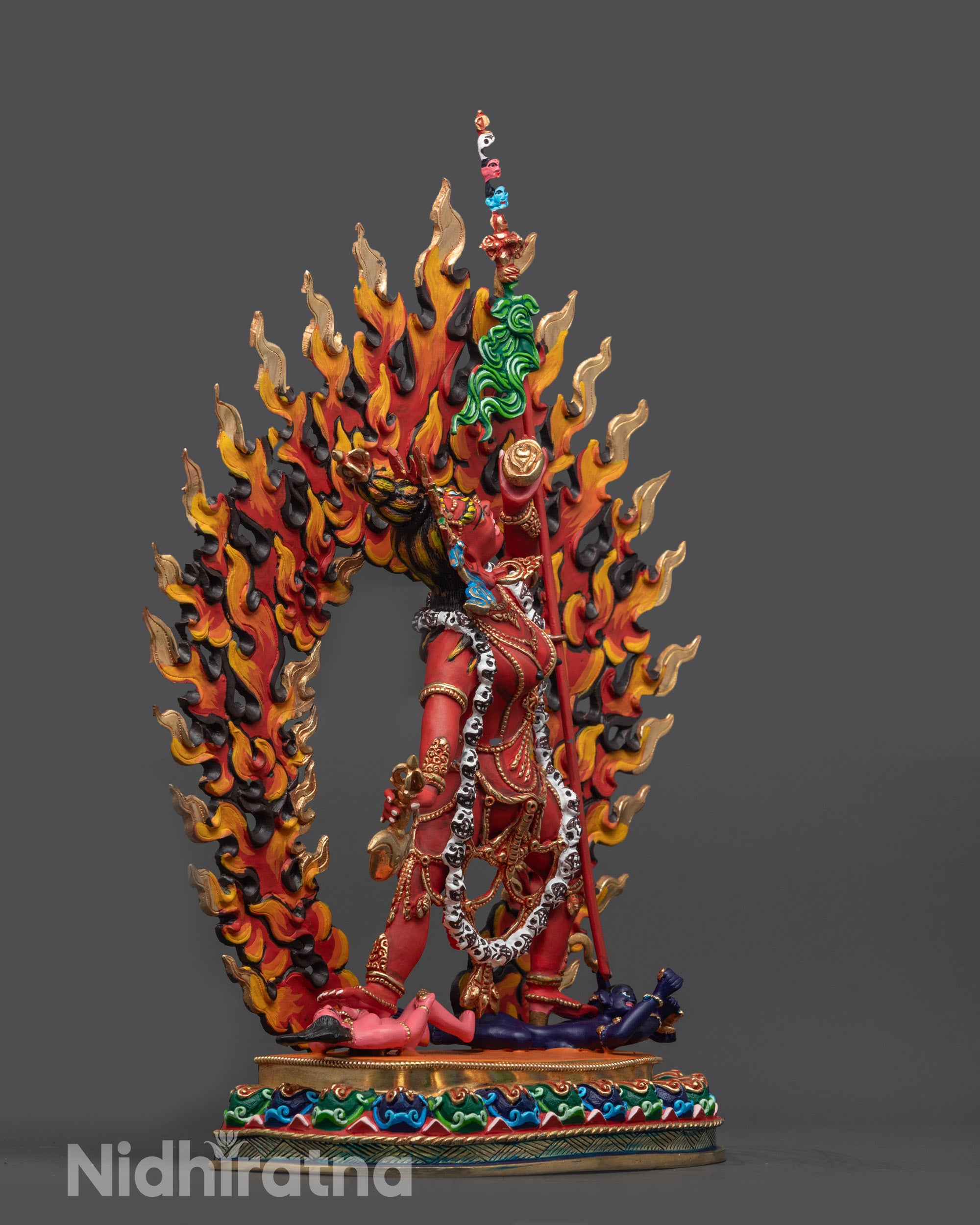 Side view of wrathful Vajrayogini sculpture standing on lotus seat with halo