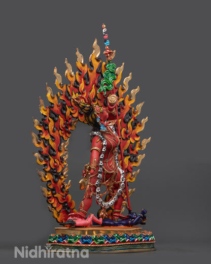 Side view of wrathful Vajrayogini sculpture standing on lotus seat with halo