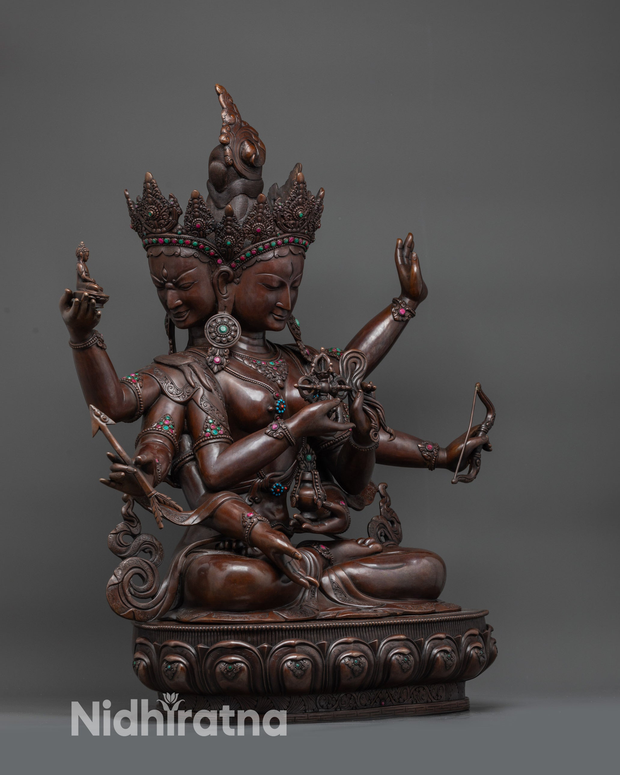 Side view oxidized Namgyalma deity with flowing robes and earthly copper hue
