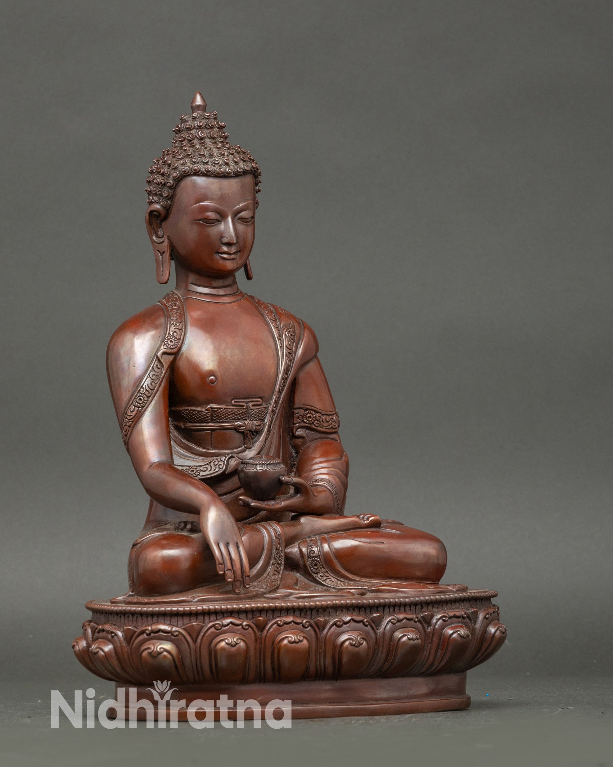 Side view oxidized Shakyamuni Buddha statue seated in meditative posture