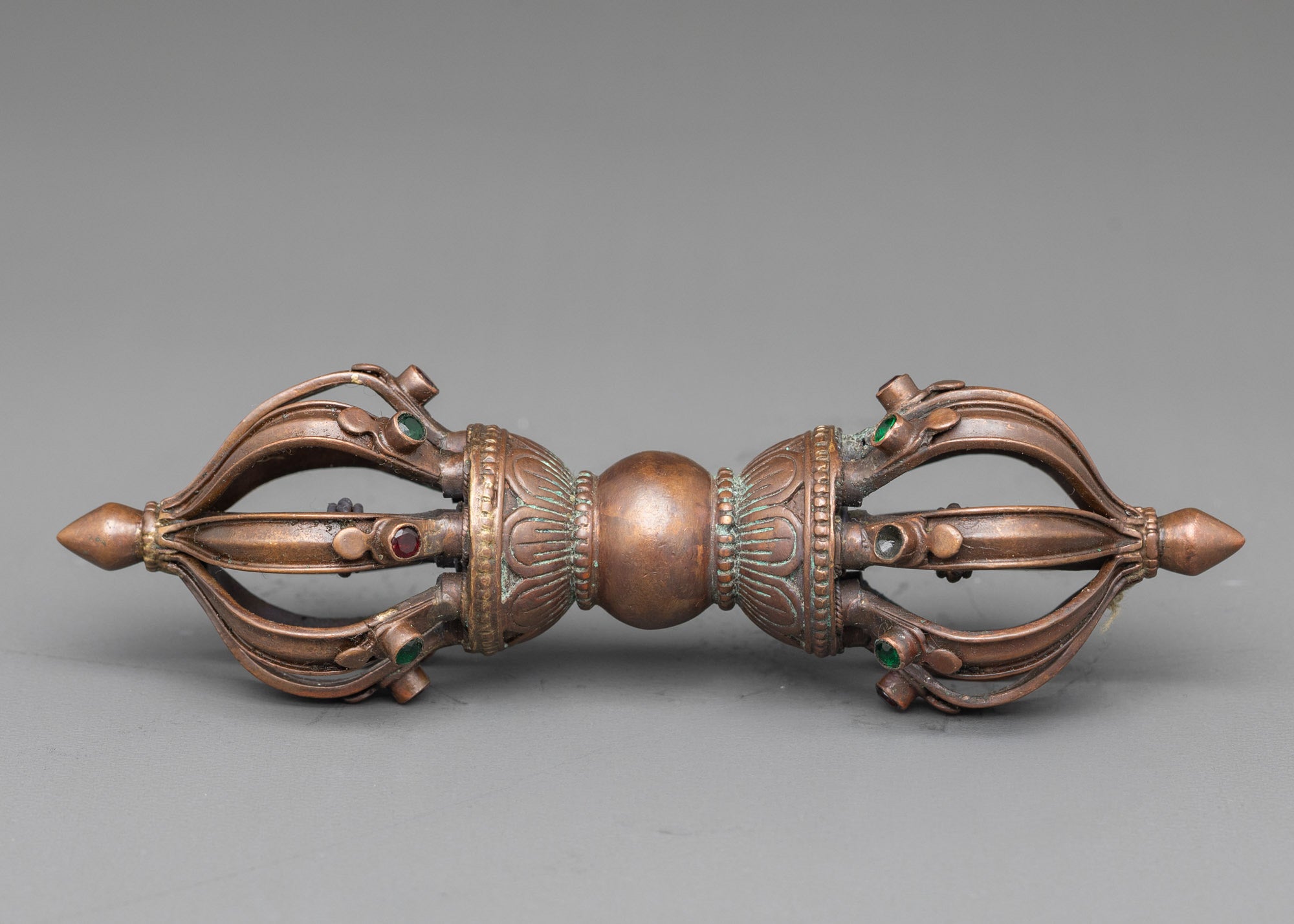 Side view oxidized copper Vajra with intricate patterns, Tibetan Buddhist ritual instrument