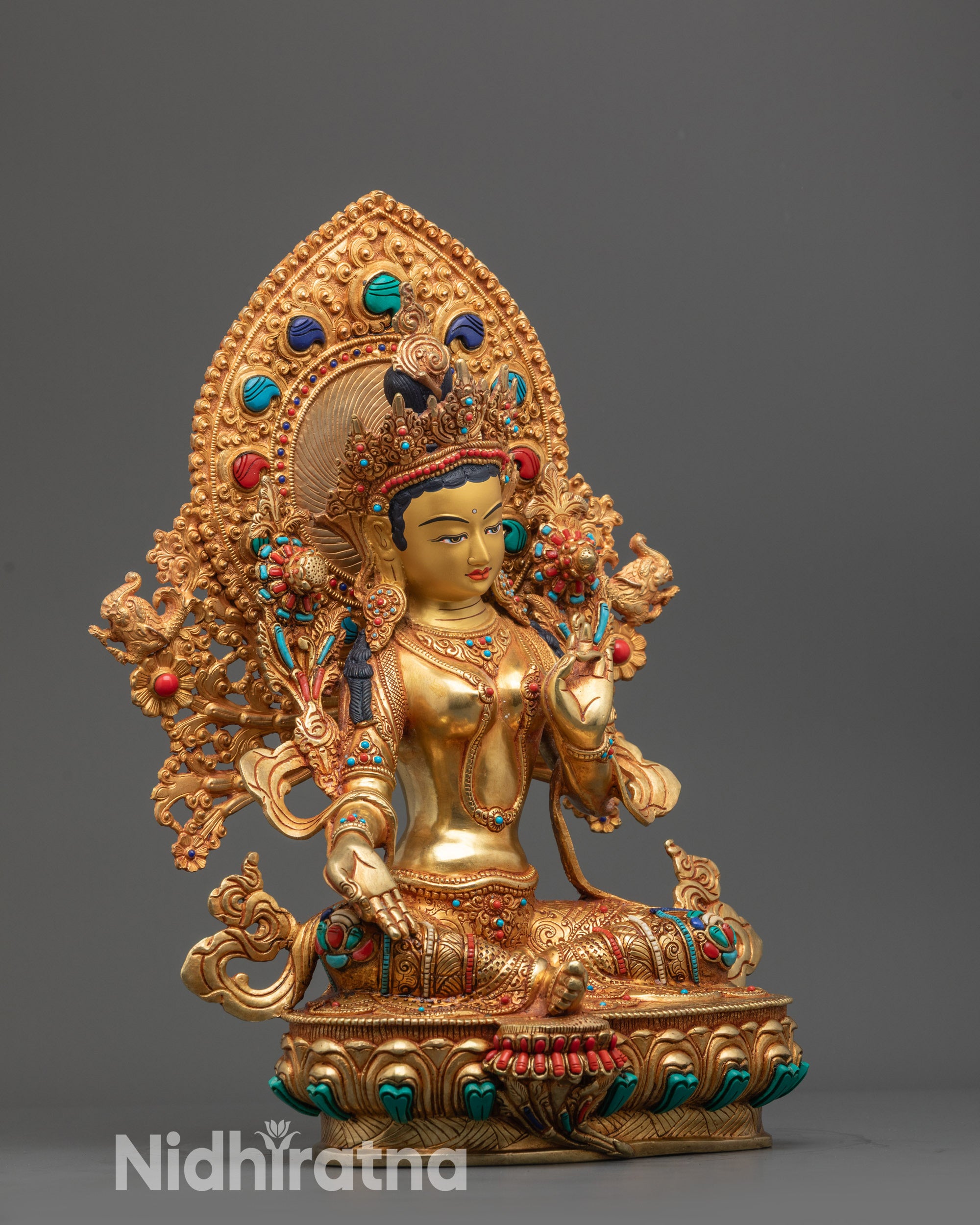 Side view showcasing Green Tara's flowing robes and semi-precious stone-adorned lotus seat.