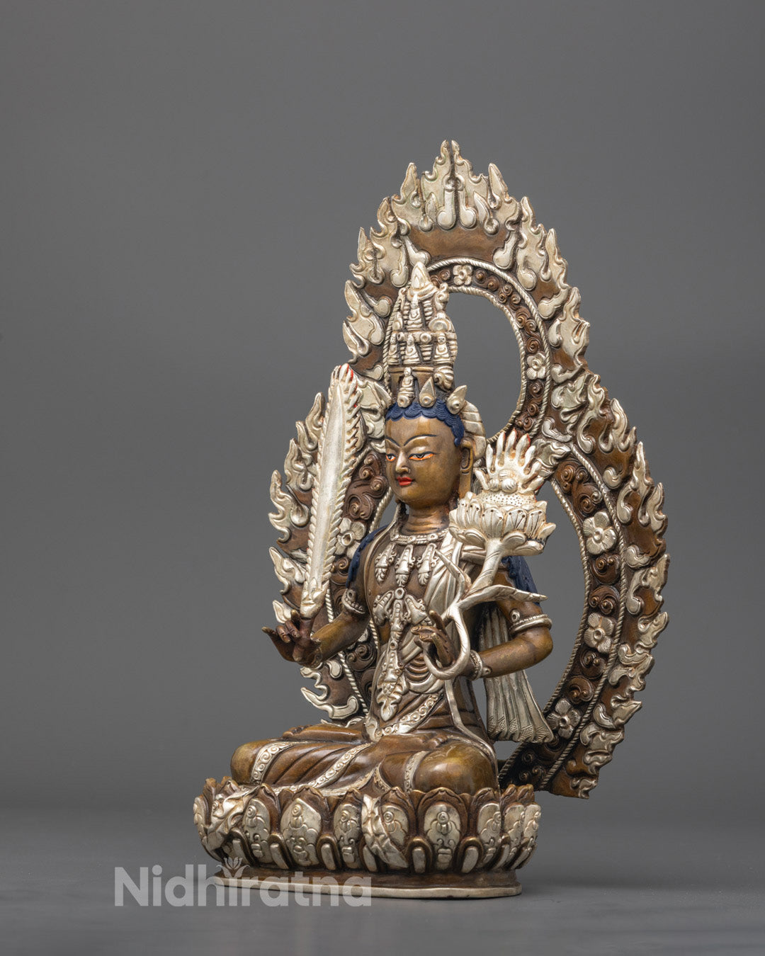 Side view showing detailed silver carvings on robe and jewelry of Akasagarbha statue