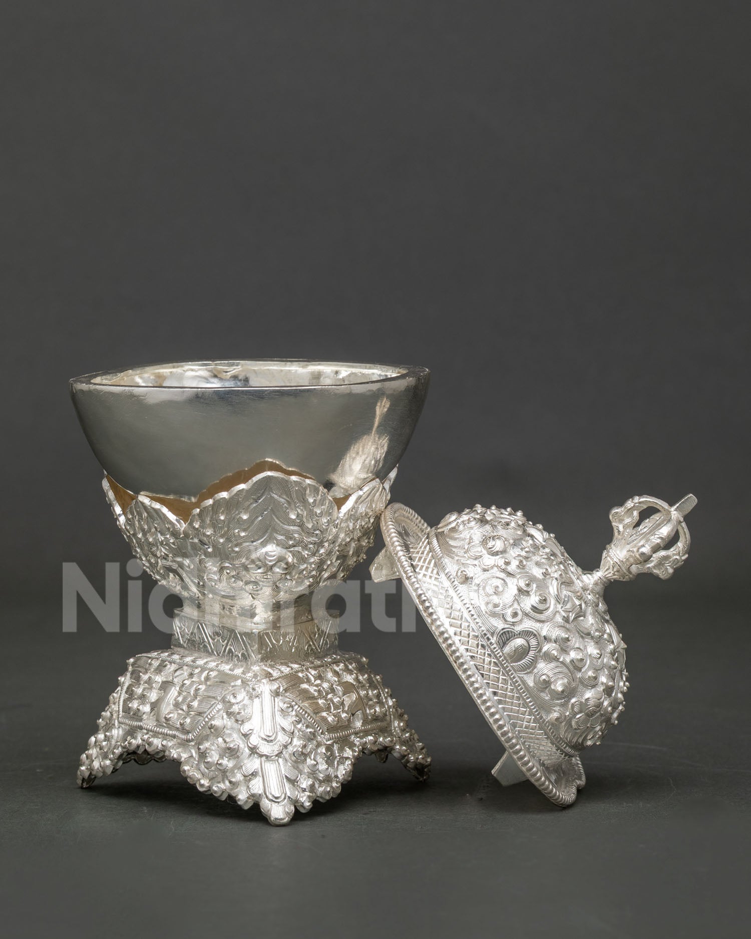 Silver plated Kapala from Patan, Nepal with handcarved floral Buddhist design.