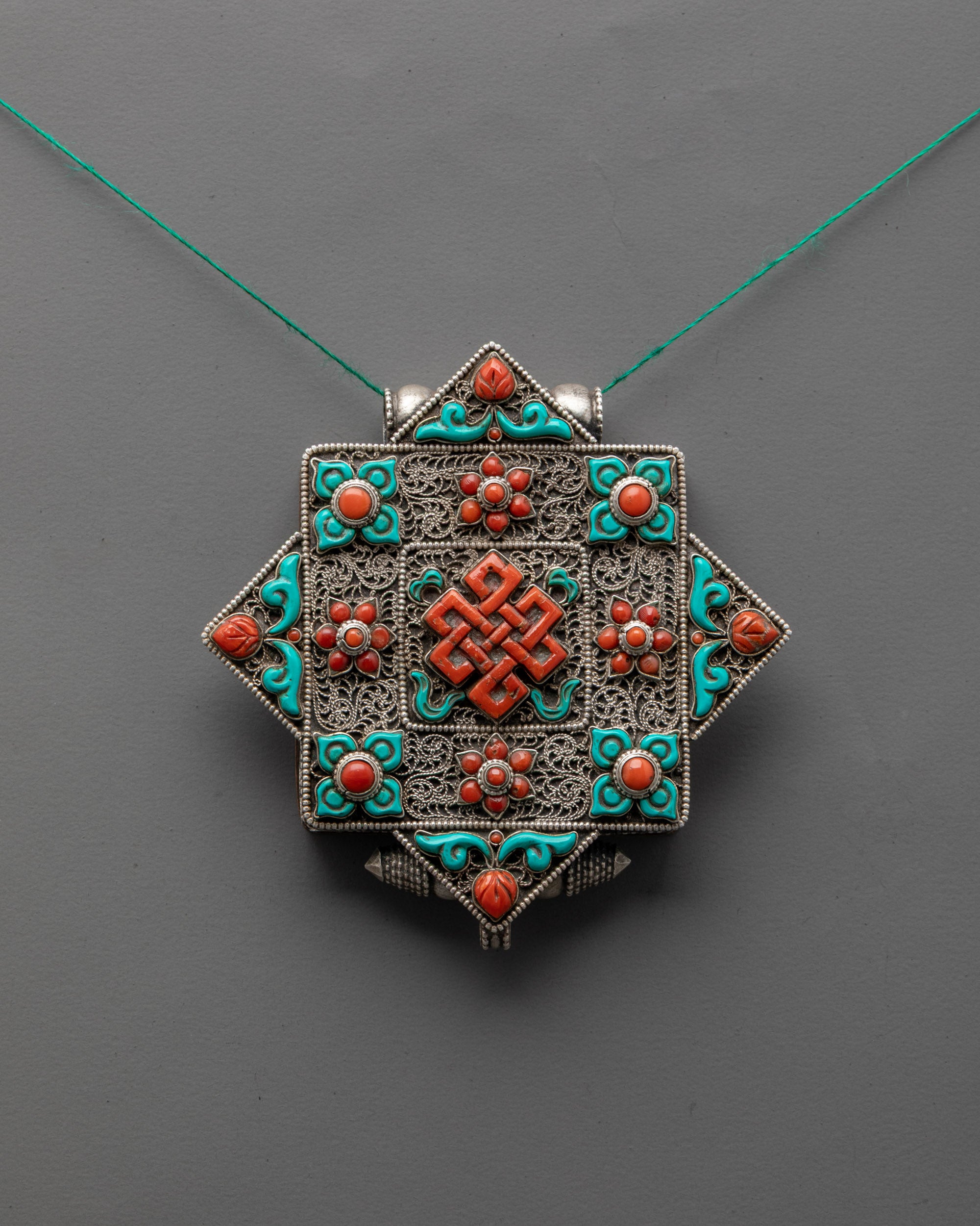 Silver Endless Knot Locket Necklace with coral and turquoise stones, handcrafted filigree design