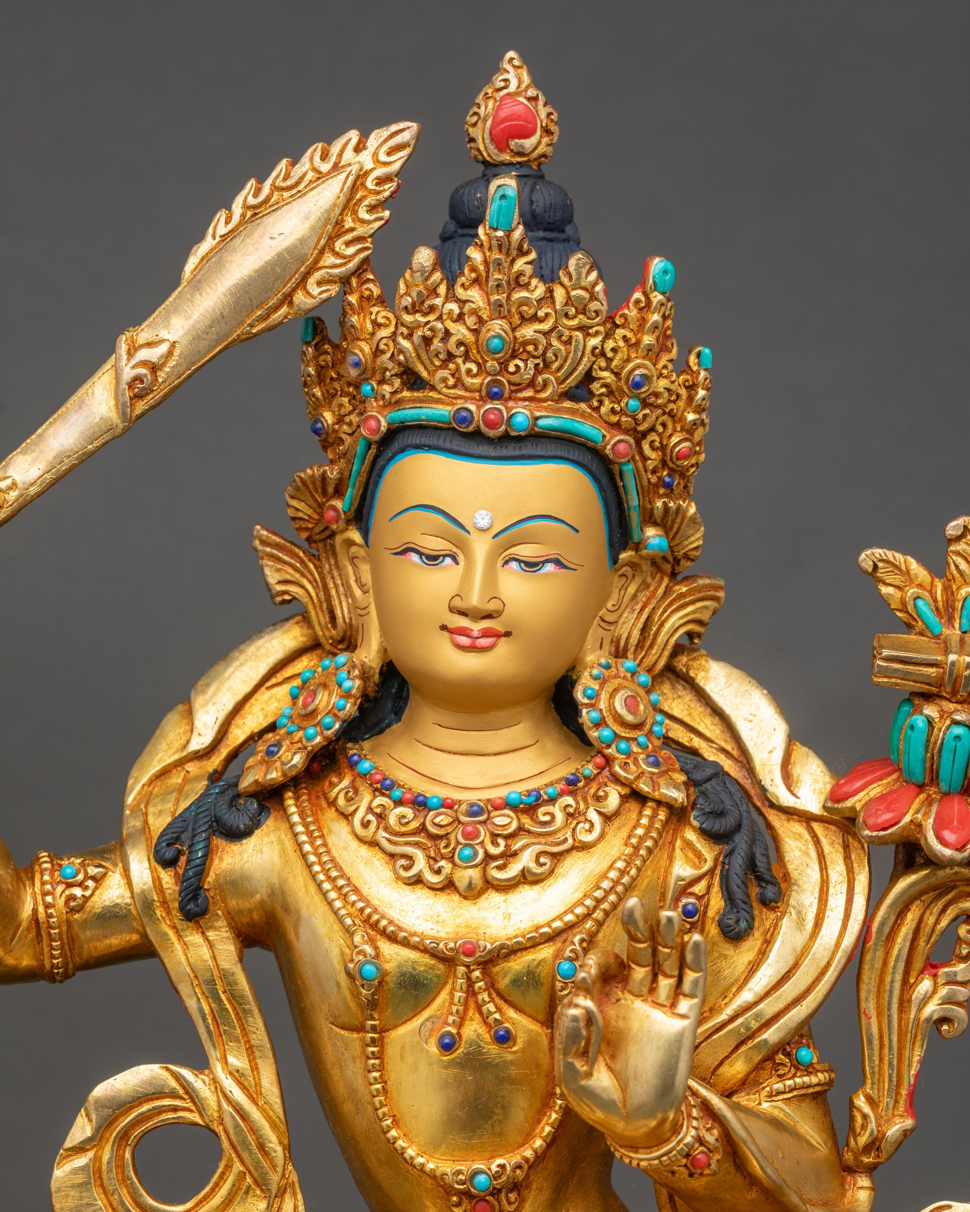 Simhanada Manjushri close up copper and gold fire-gilded Buddha sculpture