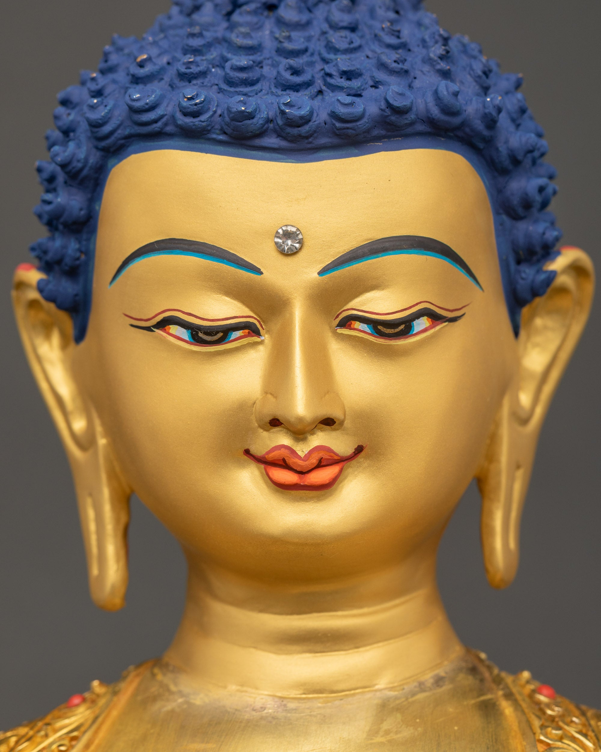 Sitting Buddha Statue serene gold-painted face detailed close up