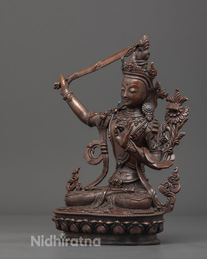 Spiritual Buddhist deity Manjushri statue in oxidized copper, richly adorned and perfect for meditation and home altar decor