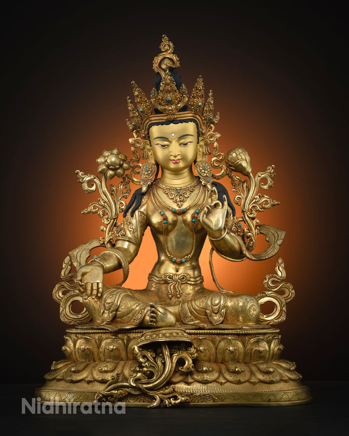 This shows full picture of Green Tara statue fully gold gilded seated on double lotus seat