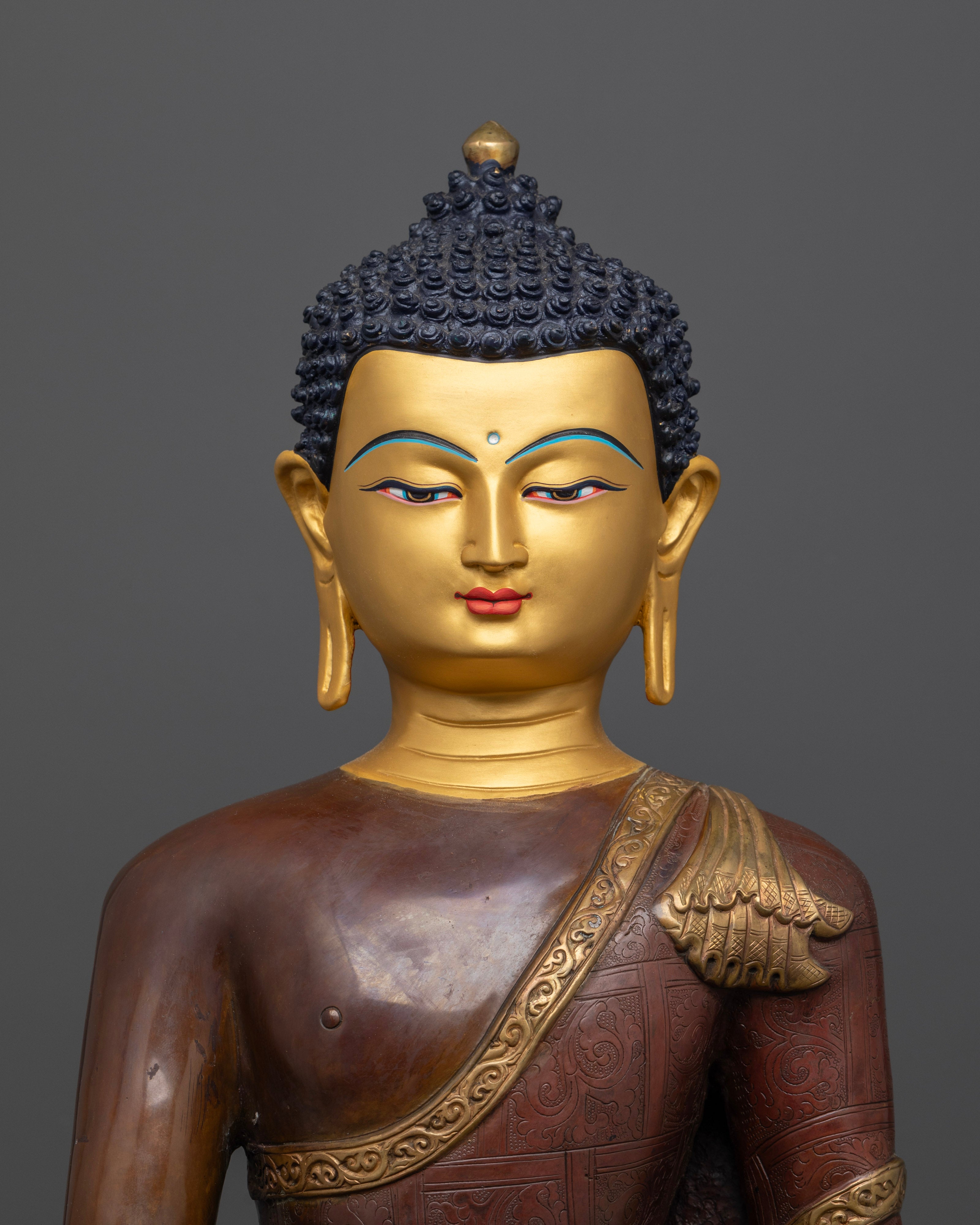 The Buddha Shakyamuni statue’s serene, gold-plated face and finely hand-carved features, showcasing expert Nepalese craftsmanship.

